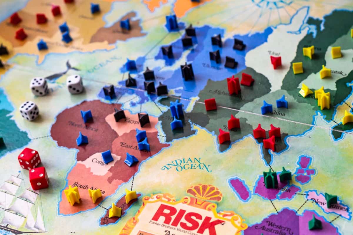 Games similar to Risk: Risk board game with cards, dice, and tokens.