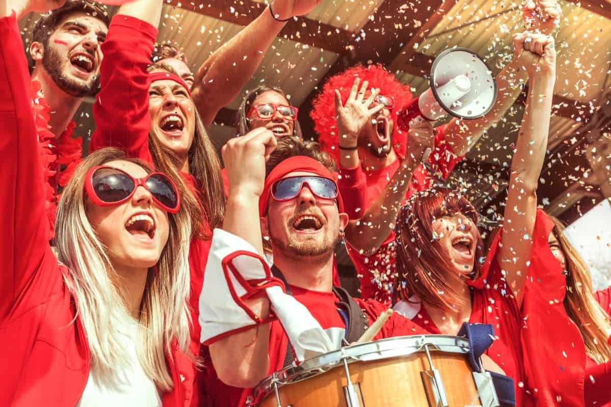 Group of friends cheering in a sports event.