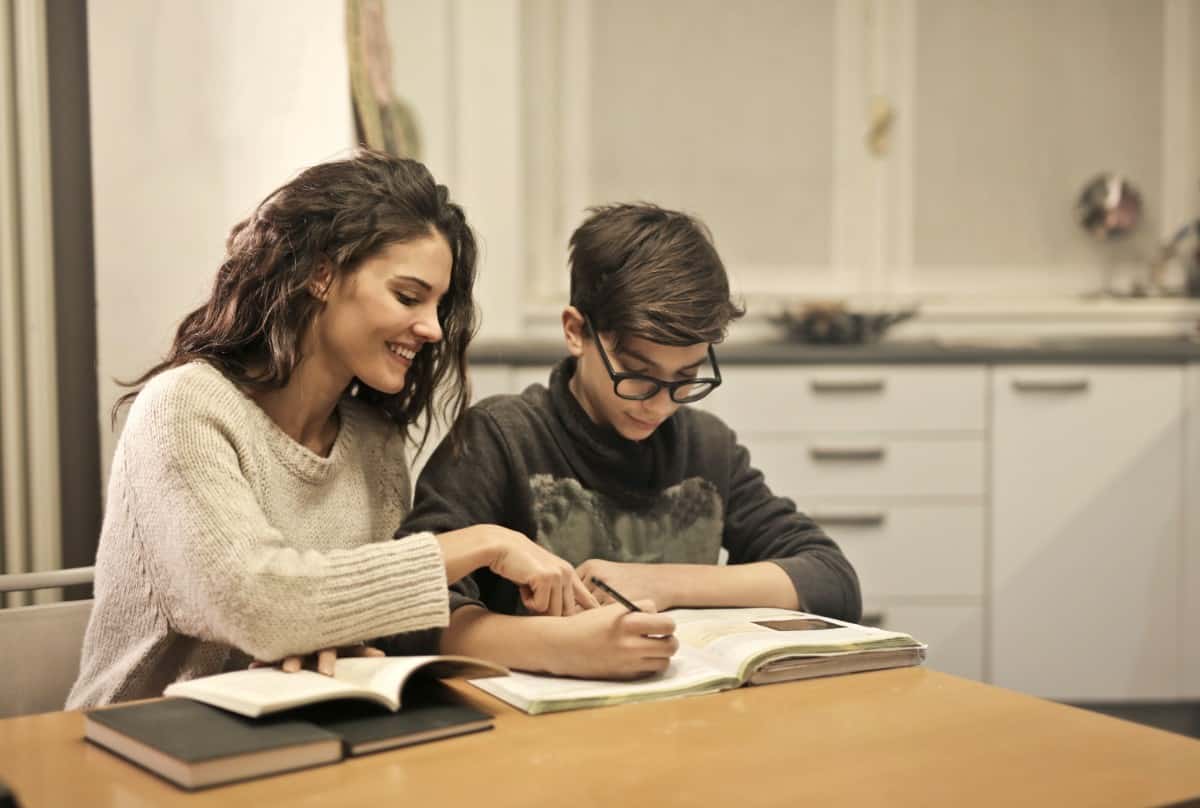 Mother guiding son with his studies.