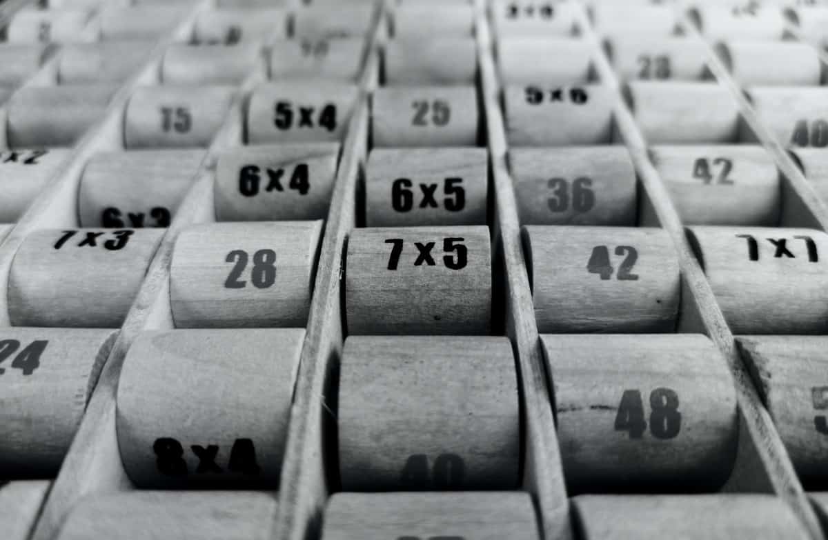 Multiplication and numbers on wooden chart.