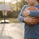 child holding basketball to check size fit