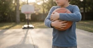 child holding basketball to check size fit
